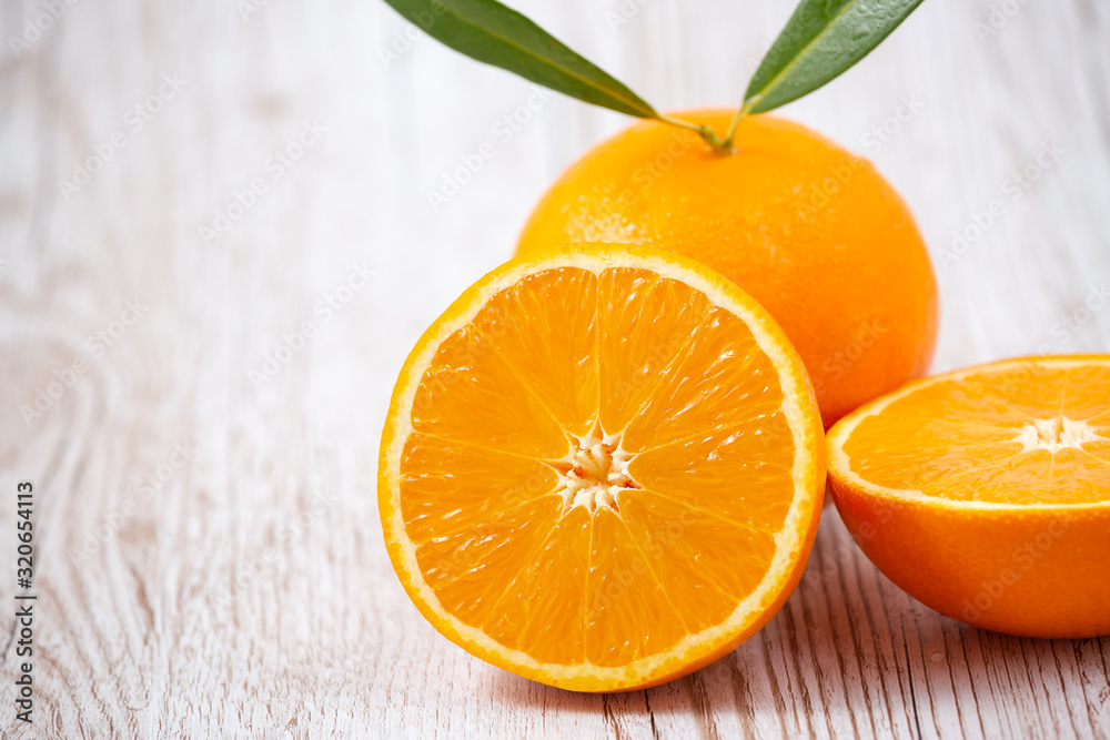 Natural fresh fruit oranges in a wooden background backdrop, half cut oranges, orange juice, vitamin C, for good health everyday Natural fresh fruit oranges in a wooden background backdrop, half cut oranges, orange juice, vitamin C, for good health everyday