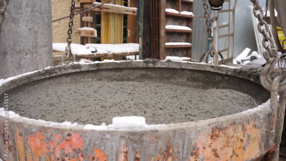 process of pouring concrete into containers