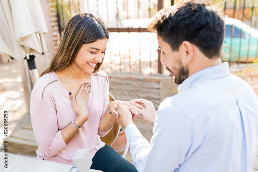 Naklejka premium Man Surprising Girlfriend With Ring