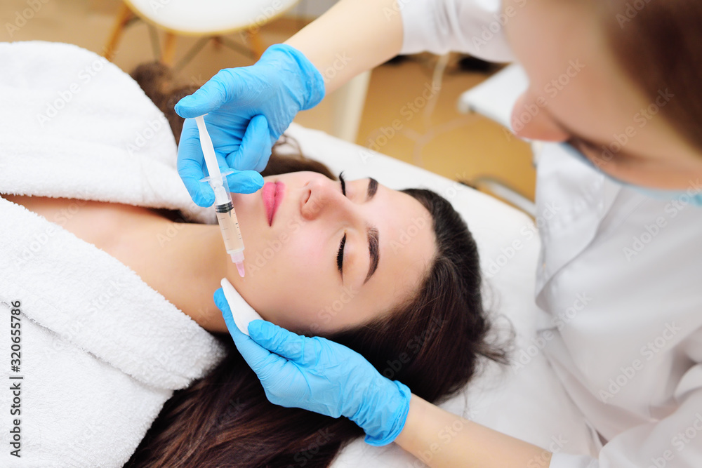 a cosmetic surgeon performs a facial skin rejuvenation procedure using an innovative technology in which plasma enriched with platelets is injected into the patient. a cosmetic surgeon performs a facial skin rejuvenation procedure using an innovative technology in which plasma enriched with platelets is injected into the patient.
