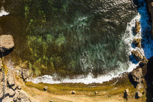 Aerial view of coast of Cura  ao in the Caribbean Sea with turquoise water  cliff  beach and beautiful coral reef around Boka Patrick