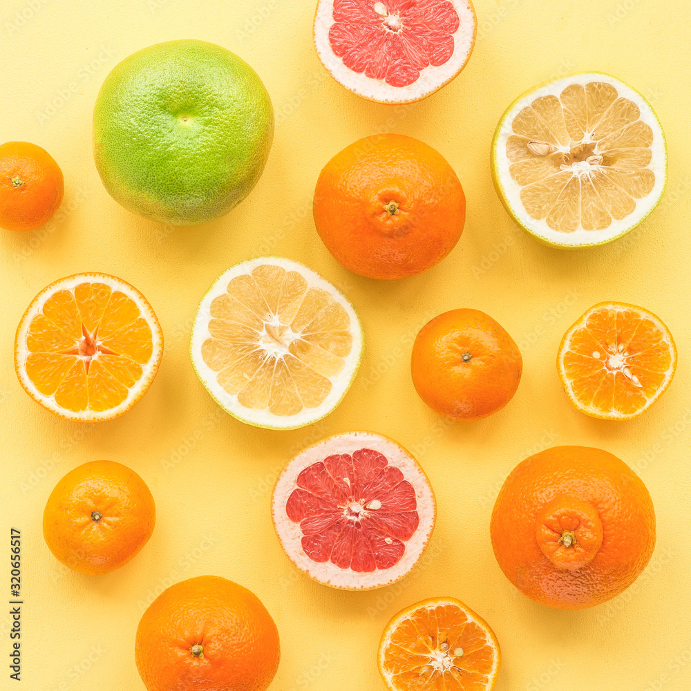 Fresh citrus fruit on yelllow background, flat lay, top view Fresh citrus fruit on yelllow background, flat lay, top view