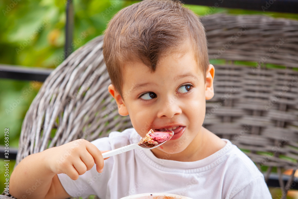 little boy with a spoon eating ice cream little boy with a spoon eating ice cream