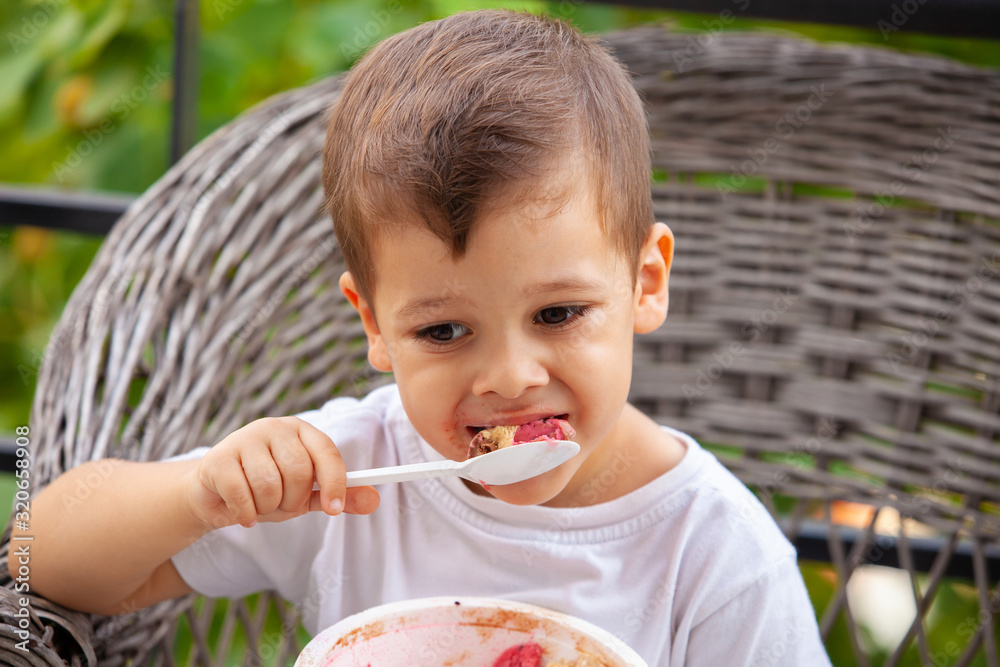 little boy with a spoon eating ice cream little boy with a spoon eating ice cream