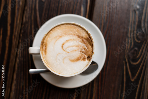 Cup of coffee latte on old wooden background