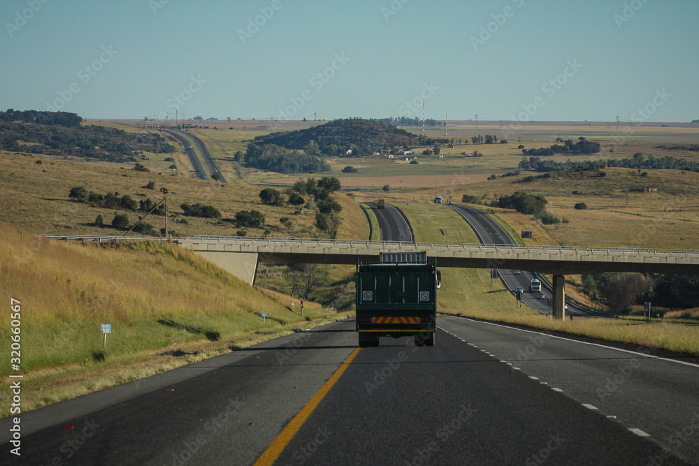Motorway in South Africa, between Johannesburg and Durban on a clear sunny day, with a bridge coming up. Motorway in South Africa, between Johannesburg and Durban on a clear sunny day, with a bridge coming up.