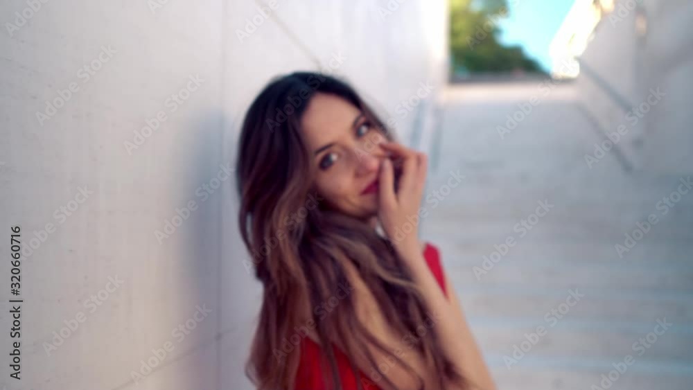 Beautiful woman in red elegant dress. Urban white background. Beautiful woman in red elegant dress. Urban white background.