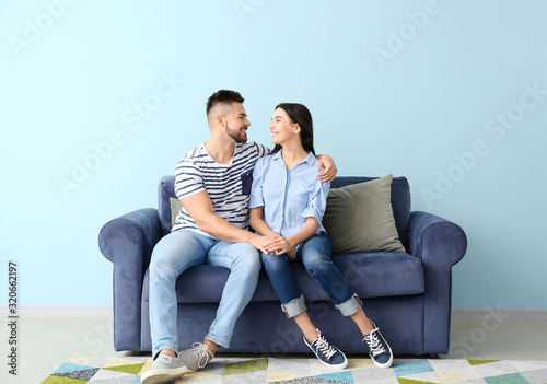 Young couple sitting on sof...
