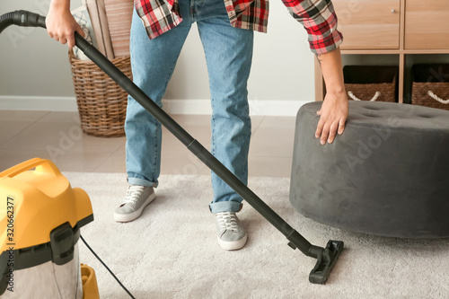 Young Asian man hoovering f...
