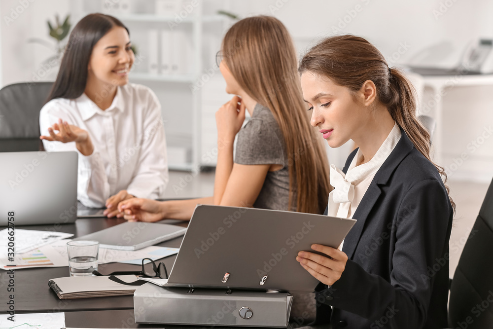 Beautiful young businesswomen working together in office Beautiful young businesswomen working together in office
