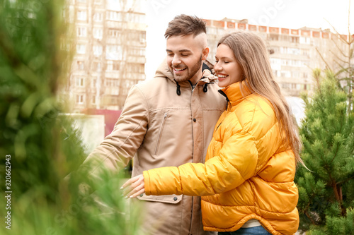 Young couple buying Christm...
