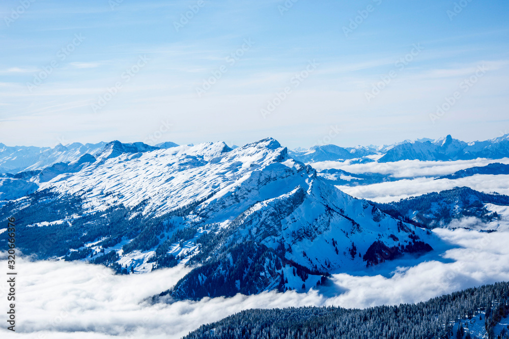 snow covered blue mountain layers of the swiss alps. switzerland alpine snowy mountains on a sunny day, blue sky snow covered blue mountain layers of the swiss alps. switzerland alpine snowy mountains on a sunny day, blue sky