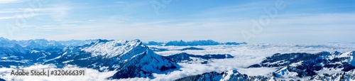 beautiful mountain panorama snow covered swiss alps. panoramic picture of the snowy mountains in switzerland, sunny blue sky © Simon