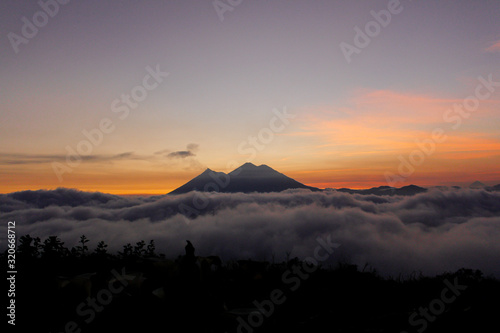 Sunset over Volcano of Fire and Acatenango Volcano - volcanoes surrounded by clouds - A view of the volcanoes of Guatemala