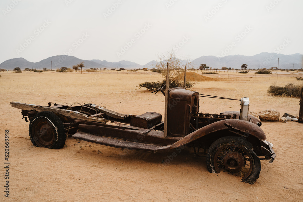 Fototapeta premium Old Timer Car Wrecks in a Desert Landscape