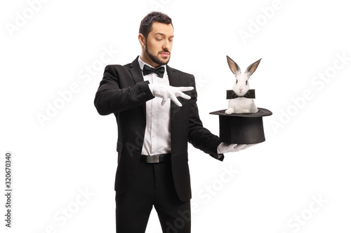 Fotobehang Young male magician making a magic trick with a rabbit in a top hat