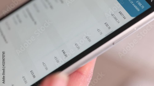 Scrolling through online bank transactions on a smartphone