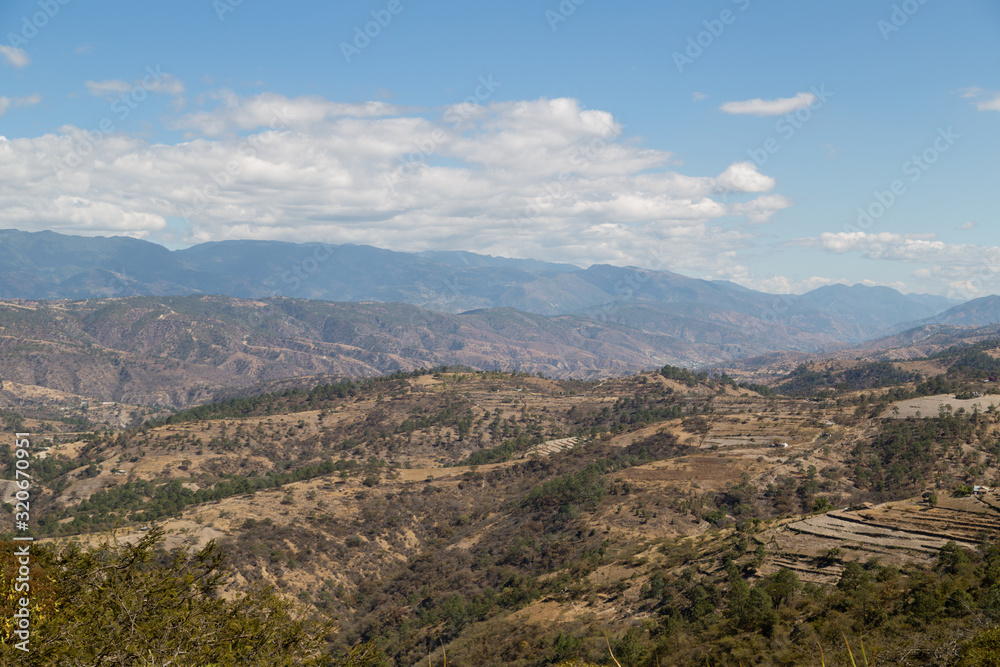 Mountains and hills on the road to Quiche in Guatemala - mountains with few trees - environmental deforestation