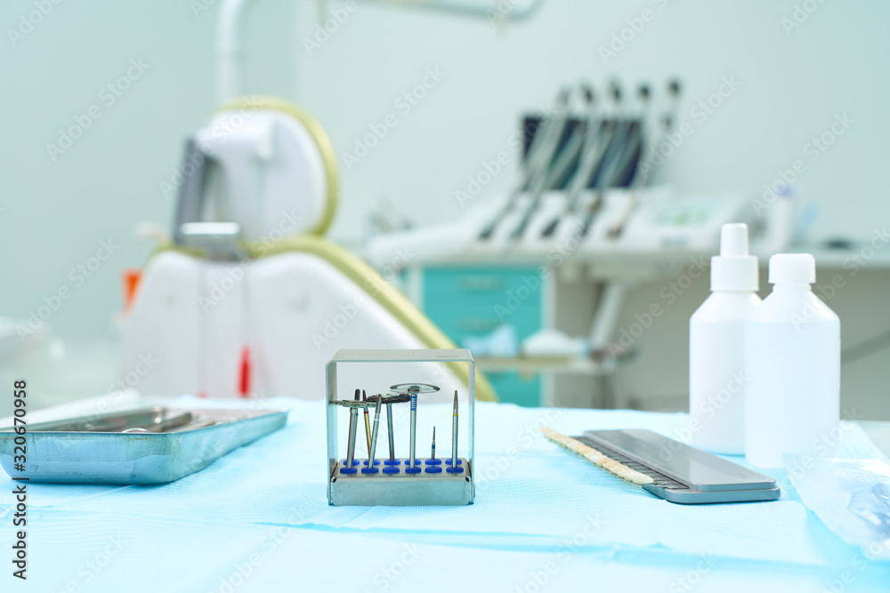 Close-up Dental Instruments. Against the background of the dental clinic Close-up Dental Instruments. Against the background of the dental clinic