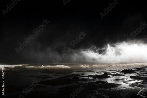 Canvas-taulu abstract mars like terrain with muddy puddles of water textures, rocks and heavy fog rolling through night background