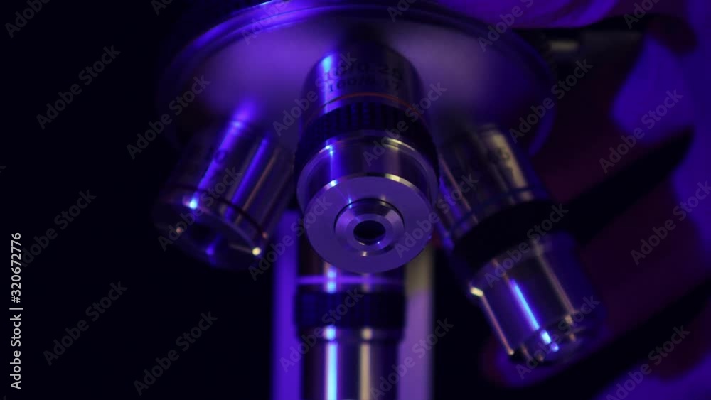 Laboratory microscope for science. The scientist twists the eyepieces of the microscope with his hand, observes the microcosm. Laboratory microscope for science. The scientist twists the eyepieces of the microscope with his hand, observes the microcosm.