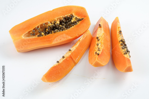 Half and slices papaya isolated on white.