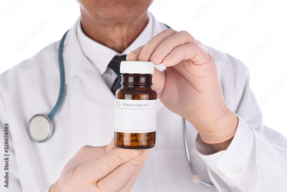 A medical professional holding a perscription bottle in his hands closeup to the camera. Focus is on the bottle, the person is unrecognizable. A medical professional holding a perscription bottle in his hands closeup to the camera. Focus is on the bottle, the person is unrecognizable.