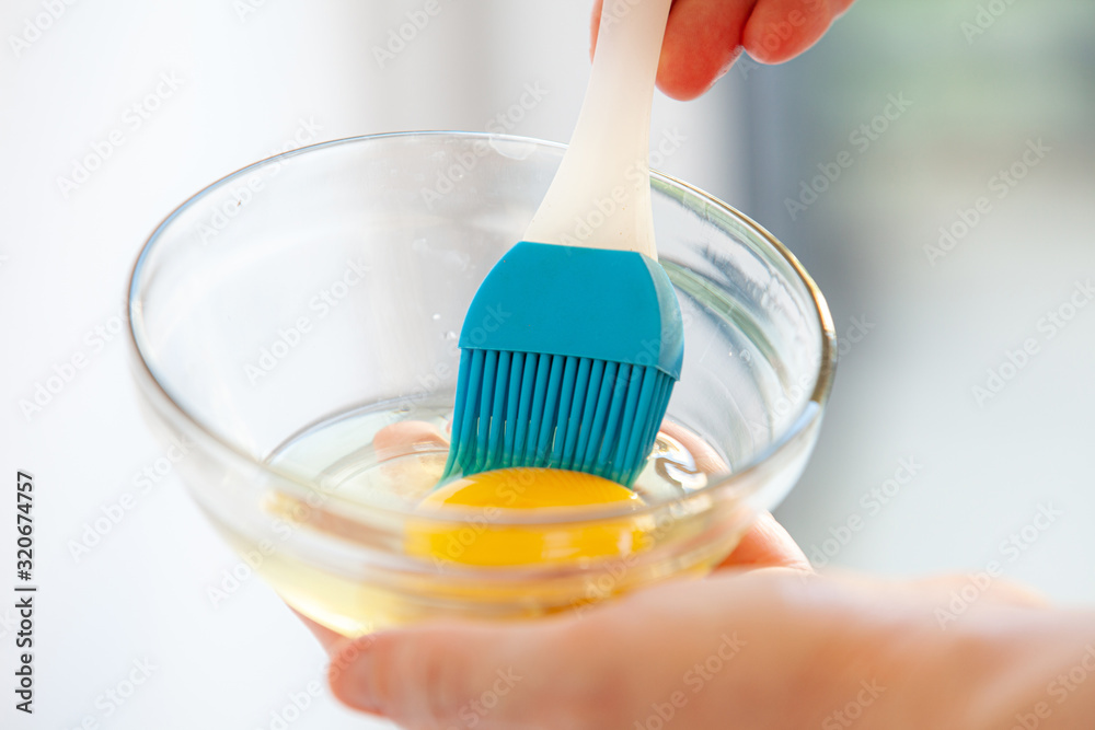 egg in a glass bowl with a brush egg in a glass bowl with a brush