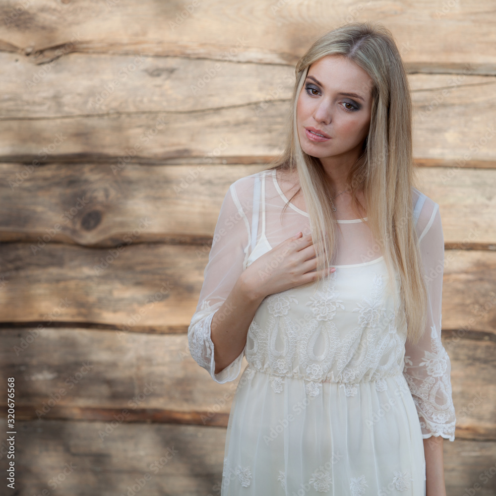 Portrait of beautiful young girl on wooden background.