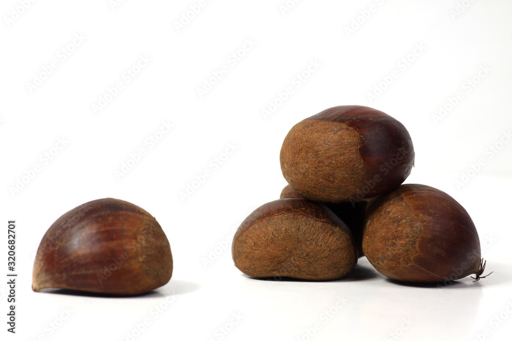a pile of sweet chestnuts isolated on white background a pile of sweet chestnuts isolated on white background