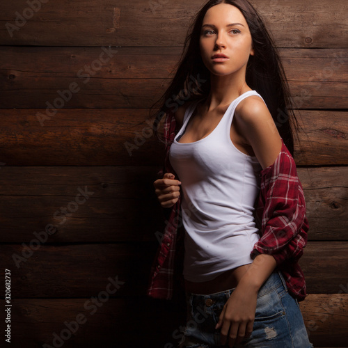 Portrait of beautiful young girl on wooden background.