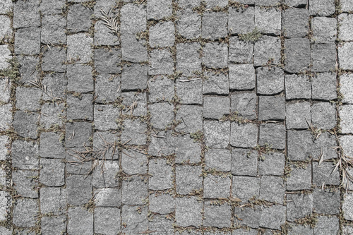 Fototapeta Naklejka Na Ścianę i Meble -  Texture of a granite pavement lined with square small granite tiles.
