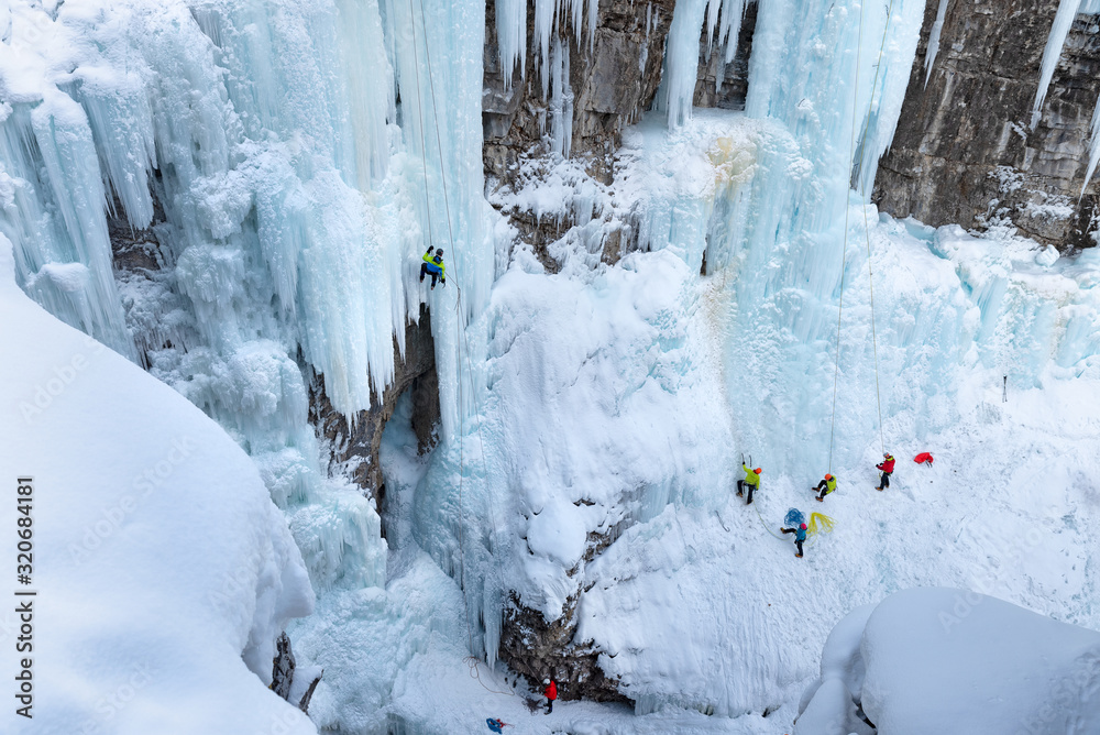 Ice climbers on frozen Upper Falls in Johnston Canyon in Banff National Park, Alberta, Canada Ice climbers on frozen Upper Falls in Johnston Canyon in Banff National Park, Alberta, Canada