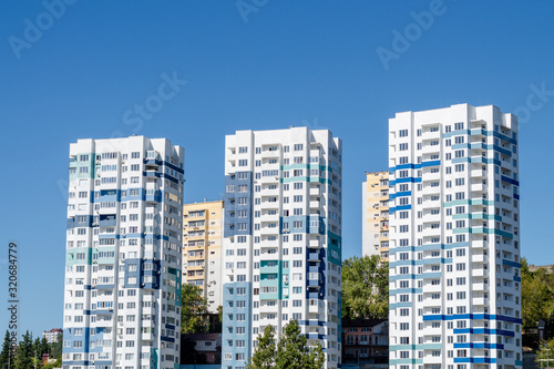 Three tall light blue modern apartment buildings. Close-up © Сергей Михайлов