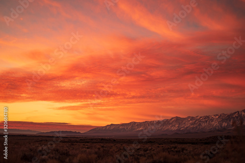 first morning sunlight illuminates snowy mountain peaks in California © mariekazalia