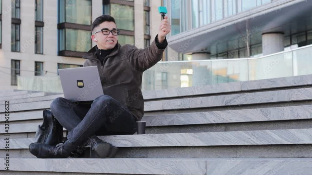 young male Asian blogger makes a selfie captures a vlog camera communicates with subscribers young male Asian blogger makes a selfie captures a vlog camera communicates with subscribers