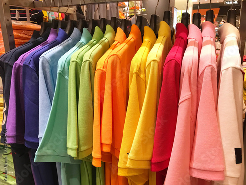 Rainbow or colorful polo shirts on hanger in shopping mall