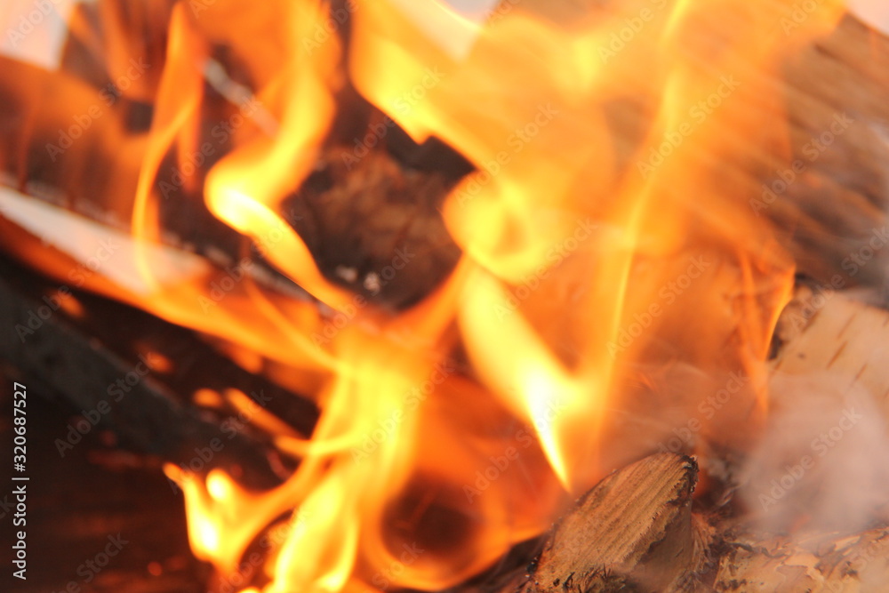 log in the flames. burning fire in the grill is large. log in the flames. burning fire in the grill is large.