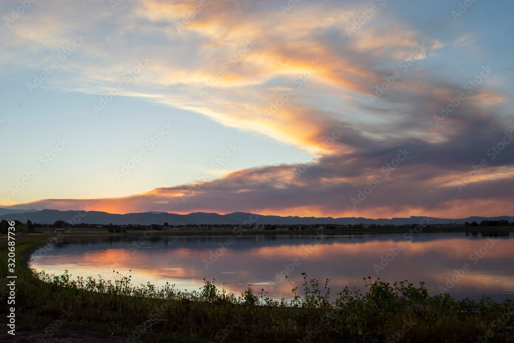 Smoky Sunset Mountain with Lake Water Reflection