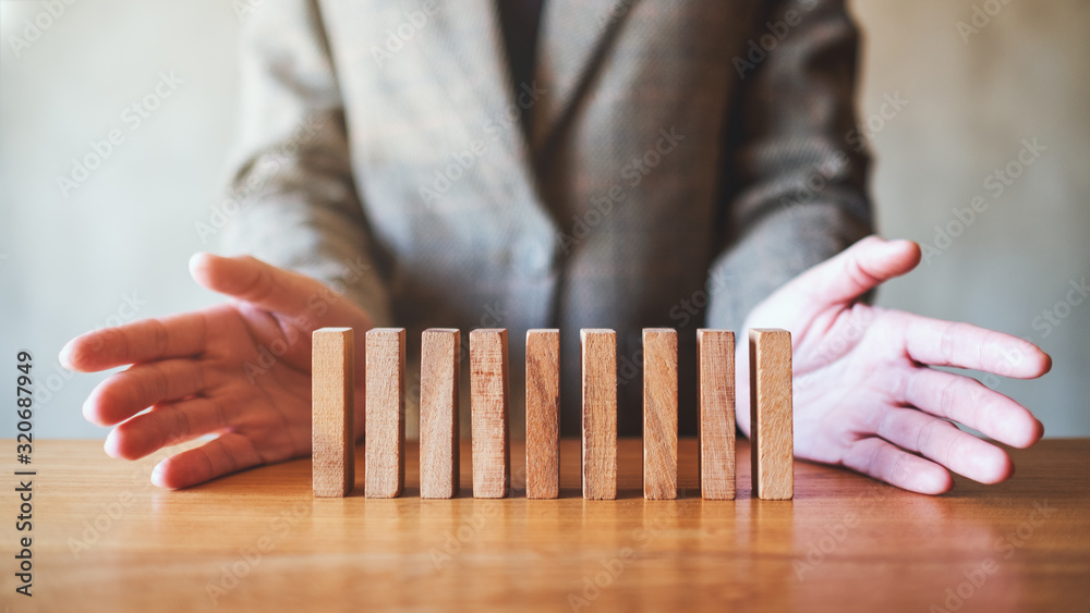 Closeup image of a businessman showing wooden block for business success concept