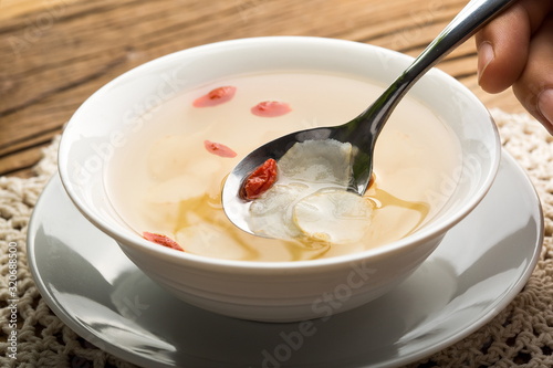 Ginseng has medicinal properties against a white background and can be dipped in water and sliced, also known as American ginseng-Panax quinquefolius