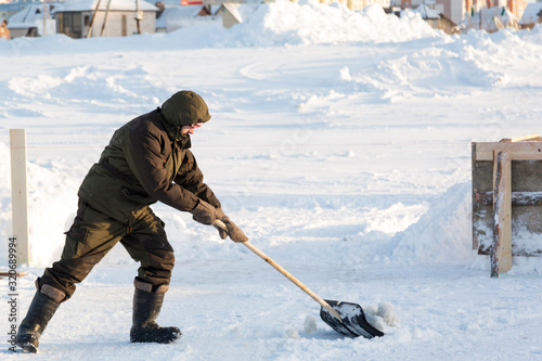 Portrait of a worker with a shovel in his hands