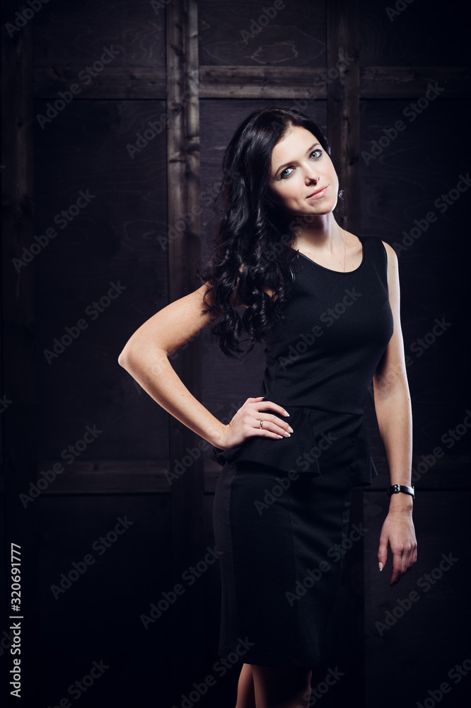 Beautiful woman in sexy evening dress against dark background. Beautiful woman in sexy evening dress against dark background.