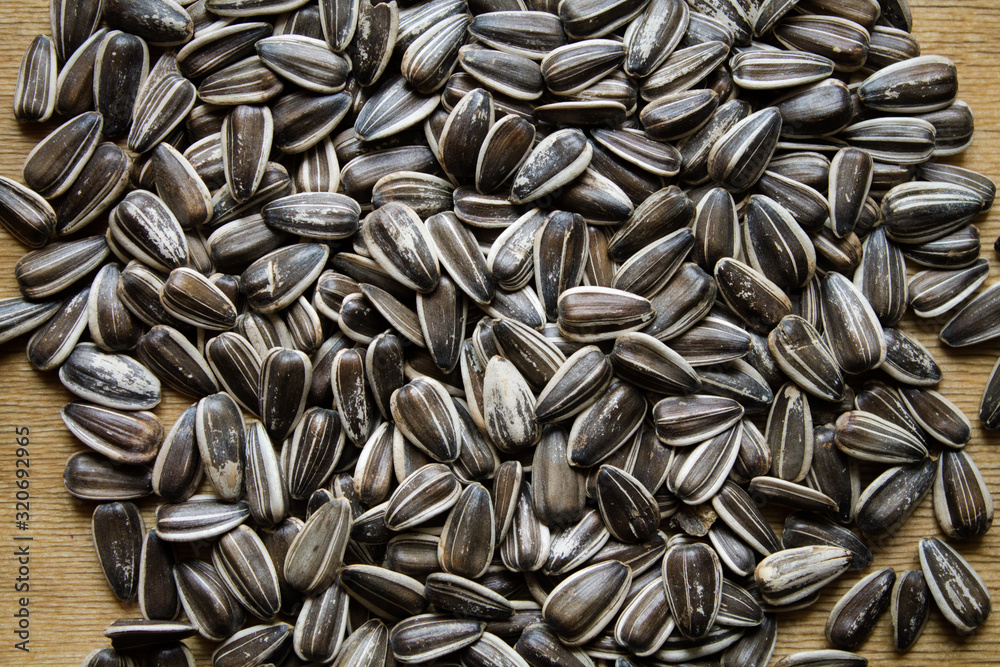 The texture of the seeds. Sunflower seeds laid out on a table. The texture of the seeds. Sunflower seeds laid out on a table.