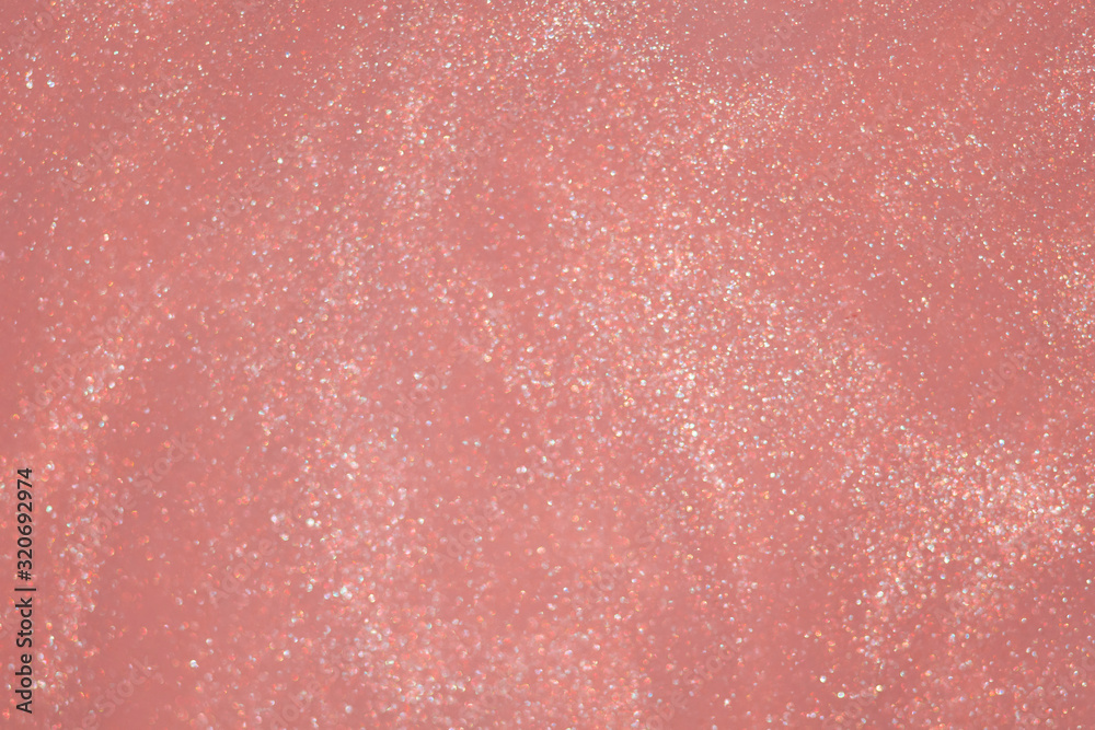 Pink golden glitter dust bokeh background.
