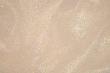 Cream color golden glitter dust bokeh background.