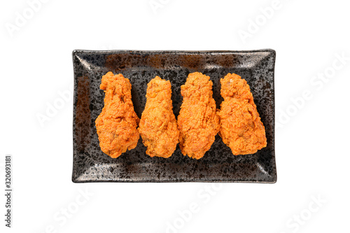 Spicy Fried chicken on blackplate on white background. photo