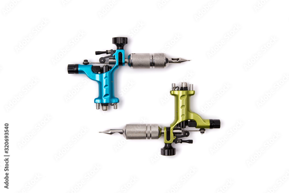 Blue and green tattoo machines isolated on white background Blue and green tattoo machines isolated on white background