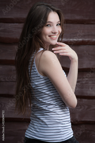 Portrait of beautiful young girl on wooden background.