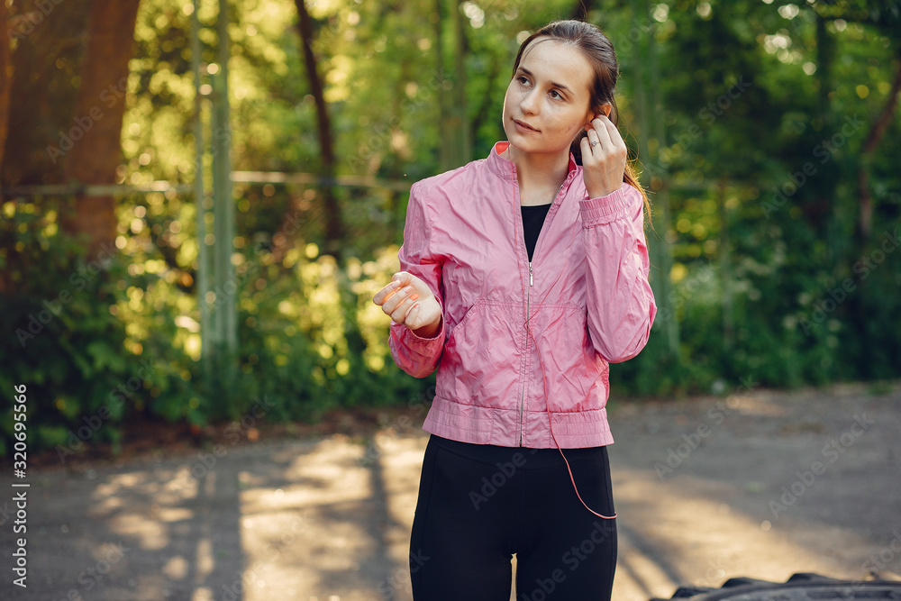 Beautiful girl in a park. Sports girl in a sportswear. Beautiful girl in a park. Sports girl in a sportswear.